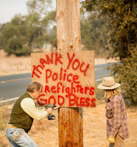 Wooden sign that reads 'thank you police and firefighters'